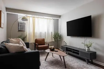 a living room with a couch and a flat screen tv at Maple Heights Serenity Libby Unit 2 in Maple Heights