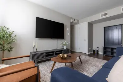 a living room with a couch and a tv on a wall at Maple Heights Serenity Libby Unit 2 in Maple Heights