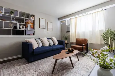 a living room with a blue couch and a table at Maple Heights Serenity Libby Unit 2 in Maple Heights