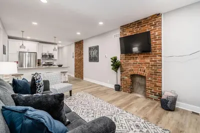 a living room with a brick fireplace and a tv at Entire Home Private Parking Fenced Yard in Columbus