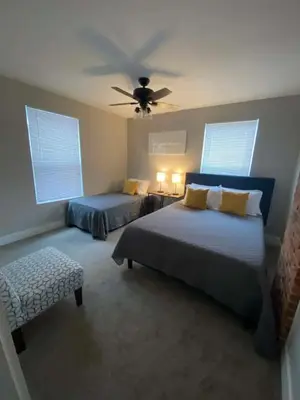 a bedroom with two beds and a ceiling fan at Entire Home Private Parking Fenced Yard in Columbus