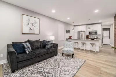 a living room with a couch and a kitchen at Entire Home Private Parking Fenced Yard in Columbus