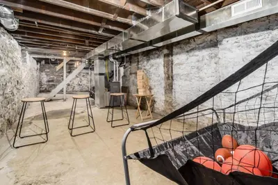 a room with a staircase with a basketball in a basket at Entire Home Private Parking Fenced Yard in Columbus