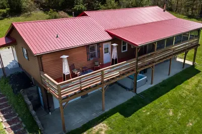 an overhead view of a house with a red roof at Spacious Cabin Near Hocking Hills and Caves with Hot Tub and Firepit in Laurelville