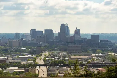 a cityscape of a city with tall buildings at Above Coffee Shop, Cincy Hilltop Apt, City Views! in Cincinnati