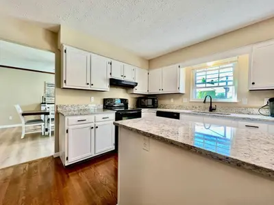 a kitchen with white cabinets and a counter top at Suburban paradise in Liberty TWP in Hughes