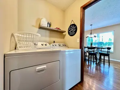 a kitchen with a dishwasher and a dining room at Suburban paradise in Liberty TWP in Hughes