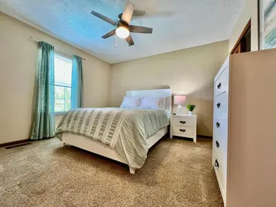 a bedroom with a bed and a ceiling fan at Suburban paradise in Liberty TWP in Hughes