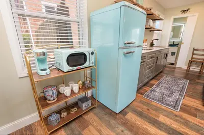 a blue refrigerator in a kitchen with a microwave at The Carriage House in Warsaw