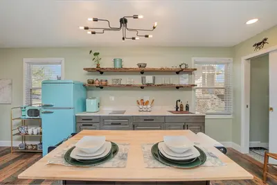 a kitchen with a table and a blue refrigerator at The Carriage House in Warsaw
