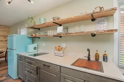 a kitchen with a sink and a blue refrigerator at The Carriage House in Warsaw