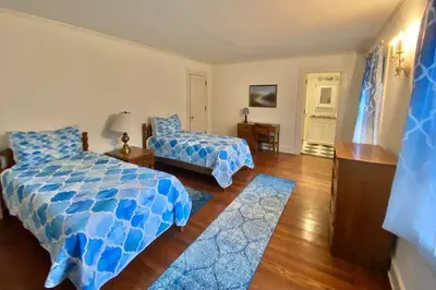 a bedroom with a bed and a chair in it at Luxurious Mansion for Large Groups in Cleveland Heights
