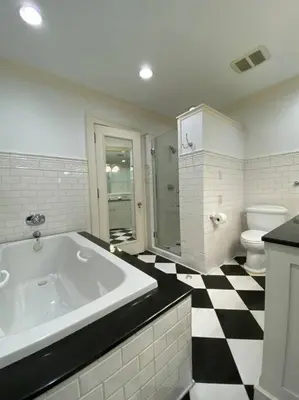 a bathroom with a black and white checkered floor at Luxurious Mansion for Large Groups in Cleveland Heights