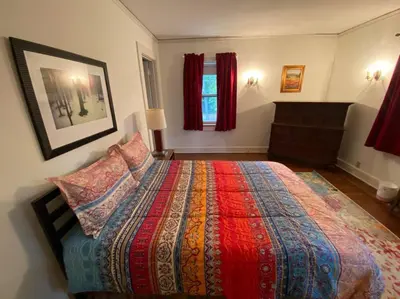 a bedroom with a large bed with a colorful blanket at Luxurious Mansion for Large Groups in Cleveland Heights