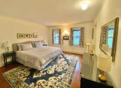 a bedroom with a bed and a rug at Luxurious Mansion for Large Groups in Cleveland Heights