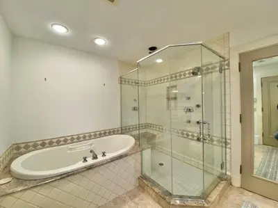 a bathroom with a tub and a glass shower at Luxurious Mansion for Large Groups in Cleveland Heights