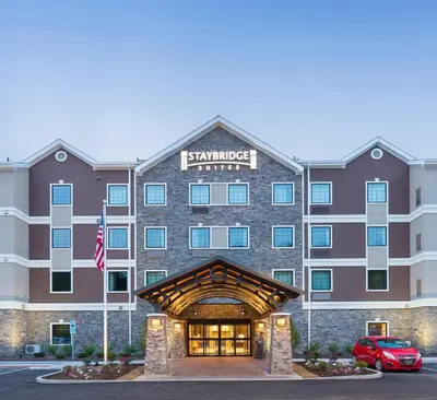a rendering of the courtyard hotel at dusk at Staybridge Suites Canton by IHG in North Canton