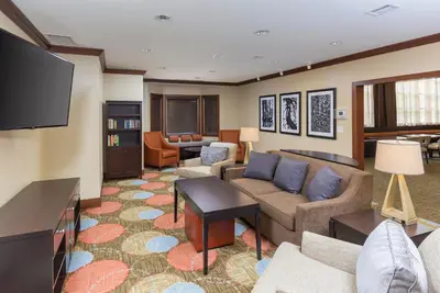 a living room with a couch and a tv at Staybridge Suites Canton by IHG in North Canton