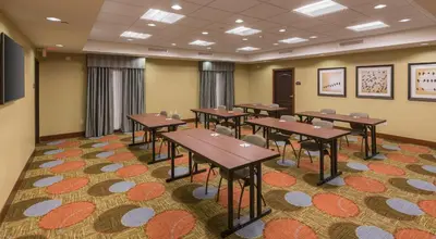 a conference room with tables and chairs on a carpet at Staybridge Suites Canton by IHG in North Canton