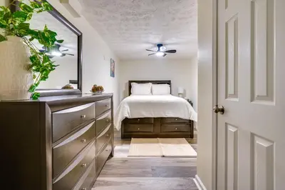 a bedroom with a bed and a dresser and a mirror at Pet-Friendly Zanesville Haven with Game Room! in Zanesville