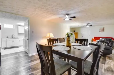 a dining room and living room with a table and chairs at Pet-Friendly Zanesville Haven with Game Room! in Zanesville