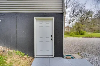 a white door on the side of a house at Pet-Friendly Zanesville Haven with Game Room! in Zanesville