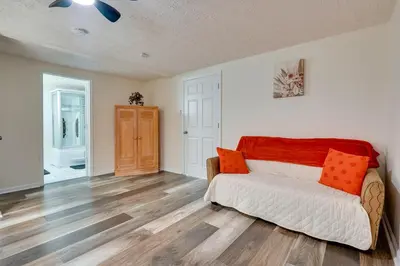 a living room with a couch and wooden floors at Pet-Friendly Zanesville Haven with Game Room! in Zanesville