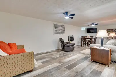 a living room with a couch and a chair at Pet-Friendly Zanesville Haven with Game Room! in Zanesville