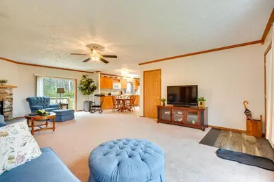 a living room with a couch and a tv at Serene Zanesville Getaway Hot Tub, 2 Decks! in Zanesville