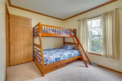 a bedroom with two bunk beds and a window at Serene Zanesville Getaway Hot Tub, 2 Decks! in Zanesville