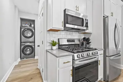 a kitchen with a stove and a microwave at Massive home downtown with Hot Tub in Columbus
