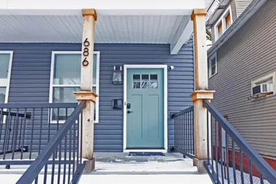 a blue house with a blue door at Massive home downtown with Hot Tub in Columbus