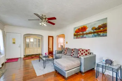 a living room with a couch and a ceiling fan at South Euclid Apt Less Than 10 Mi to Downtown Cleveland! in South Euclid