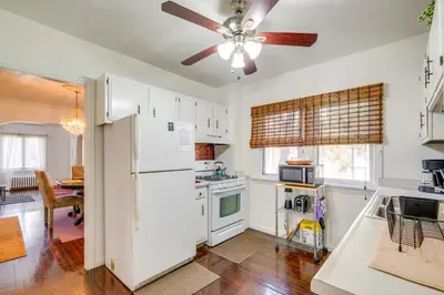 a kitchen with white appliances and a ceiling fan at South Euclid Apt Less Than 10 Mi to Downtown Cleveland! in South Euclid