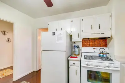a kitchen with white cabinets and a white refrigerator at South Euclid Apt Less Than 10 Mi to Downtown Cleveland! in South Euclid