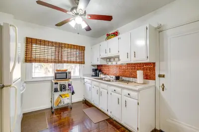 a kitchen with white cabinets and a ceiling fan at South Euclid Apt Less Than 10 Mi to Downtown Cleveland! in South Euclid
