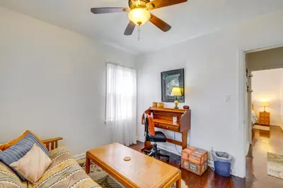 a living room with a ceiling fan and a piano at South Euclid Apt Less Than 10 Mi to Downtown Cleveland! in South Euclid