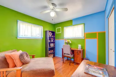 a living room with green and blue walls and a couch at Charming Home - 4 Mi to Euclid Creek Reservation in South Euclid