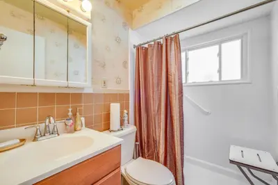 a bathroom with a sink and a toilet and a window at Charming Home - 4 Mi to Euclid Creek Reservation in South Euclid