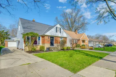 a brick house with a gray roof at Charming Home - 4 Mi to Euclid Creek Reservation in South Euclid