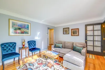 a living room with a couch and two blue chairs at Charming Home - 4 Mi to Euclid Creek Reservation in South Euclid