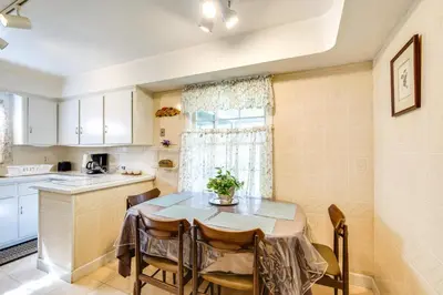 a kitchen and dining room with a table and chairs at Cleveland Heights Home with Sunroom Park Across St! in Cleveland Heights