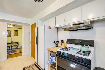 a kitchen with a stove and a refrigerator at Cleveland Heights Home with Sunroom Park Across St! in Cleveland Heights