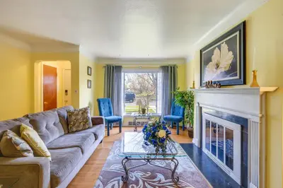 a living room with a couch and a fireplace at Cleveland Heights Home with Sunroom Park Across St! in Cleveland Heights