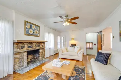 a living room with a fireplace and a ceiling fan at Trendy South Euclid Apt - 5 Mi to Cleveland Clinic in South Euclid