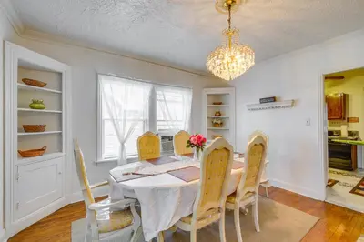a dining room with a table and chairs and a chandelier at Trendy South Euclid Apt - 5 Mi to Cleveland Clinic in South Euclid