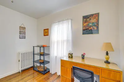 a desk with a chair in a room with a window at Trendy South Euclid Apt - 5 Mi to Cleveland Clinic in South Euclid
