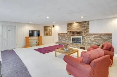 a living room with two chairs and a fireplace at Spacious Studio - 5 Mi to MGM Northfield Park! in Maple Heights