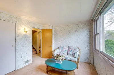 a room with a chair and a table and a window at Spacious Studio - 5 Mi to MGM Northfield Park! in Maple Heights