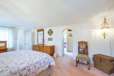 a bedroom with a bed and a chair in it at Spacious Studio - 5 Mi to MGM Northfield Park! in Maple Heights